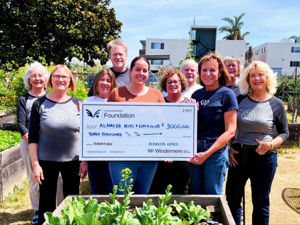 Alameda Post - a group of people from the Alameda Boys and Girls Club and Windermere stand around a large check