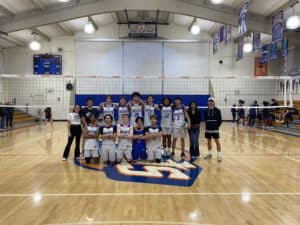 Alameda Post - the SJND Pilots volleyball team poses together on the court