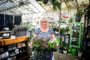Alameda Post - Maggie Adams holds a tray of plants in Magpie & Thorn