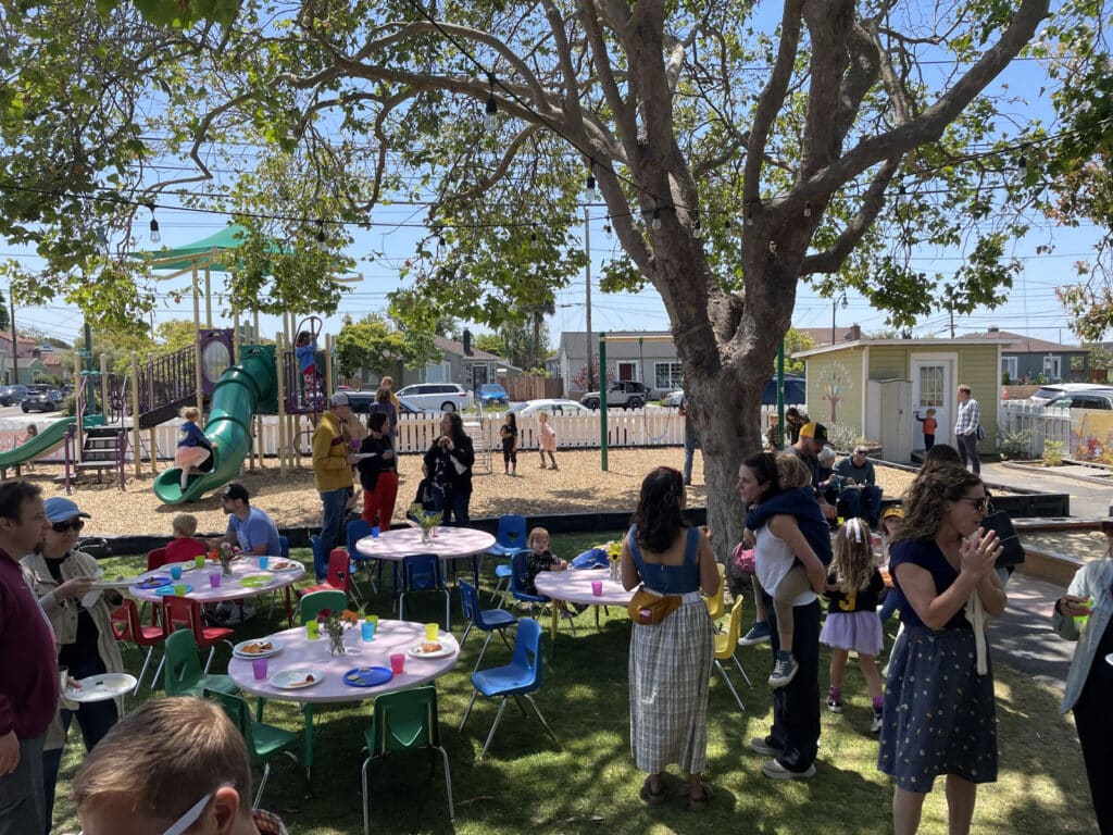 Alameda Post - the lawn at Kiddie Kampus with chairs, tables, and party attendees 