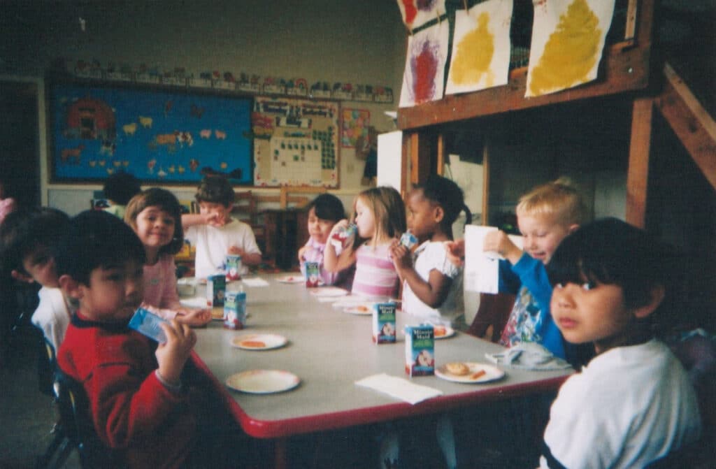 Alameda Post - a group of preschoolers sit around a table and enjoy a snack