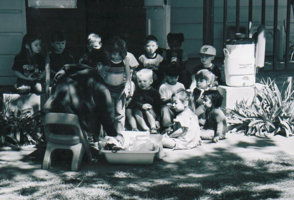 Alameda Post - a group of preschoolers gathered outside at Kiddie Kampus in a black and white photo