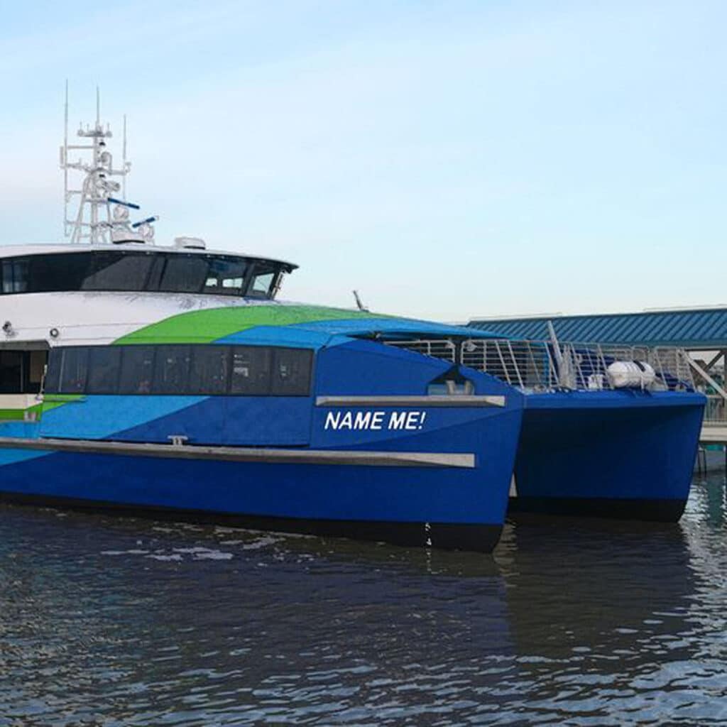 Alameda Post - A SF Bay Ferry on the water. Small white letters on the side of the boat say "Name me!"