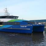 Alameda Post - A SF Bay Ferry on the water. Small white letters on the side of the boat say "Name me!"