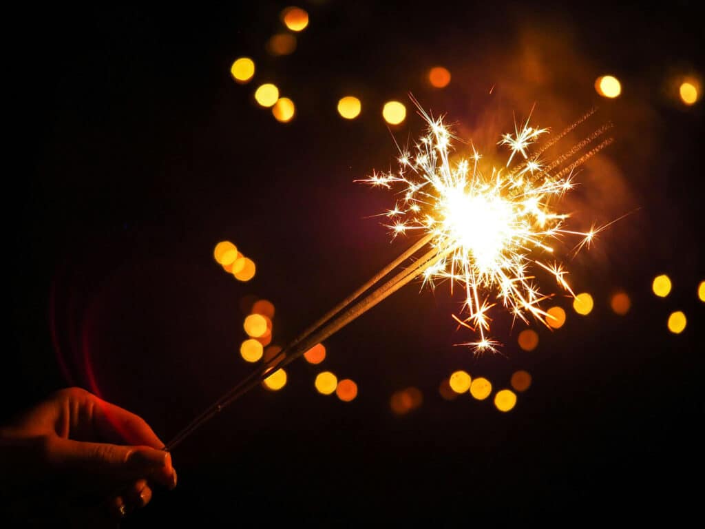 Alameda Post - a hand holds a sparkler 