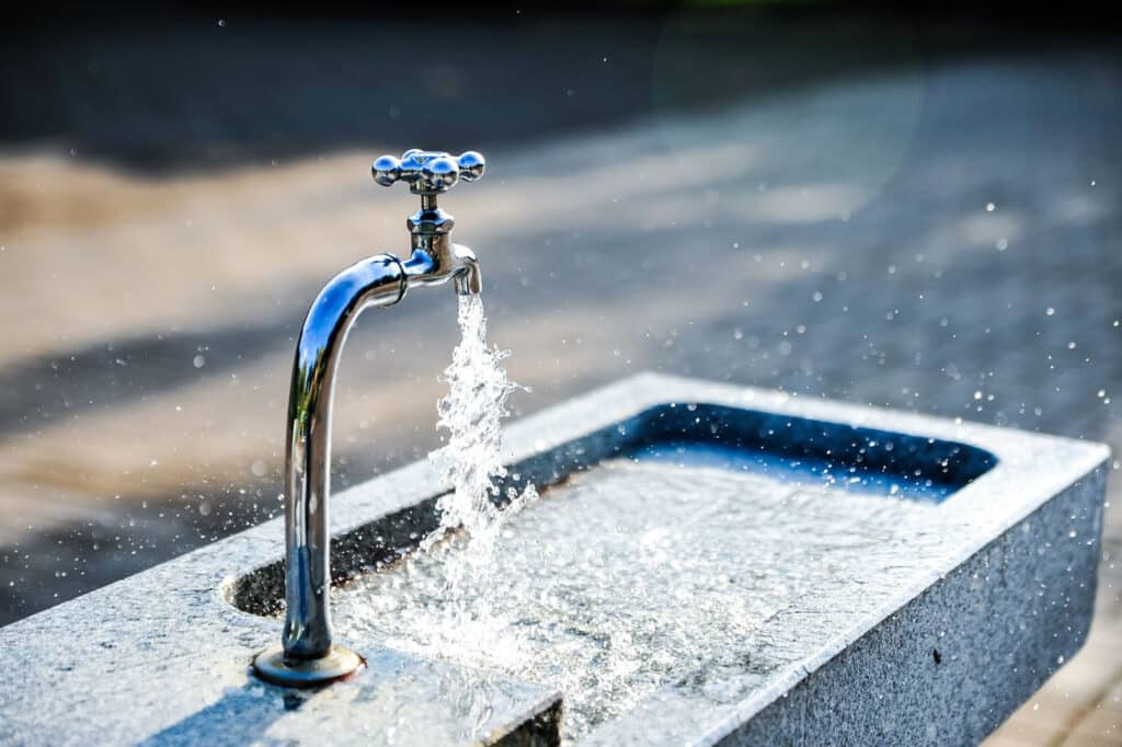 Alameda Post - a faucet running with water