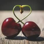 Alameda Post - two cherries connected at the stem, with the stem in the shape of a heart