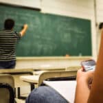 Alameda Post - A teacher teaches while a student texts on their phone