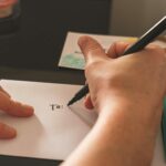 Alameda Post - A close up photo of a person filling gout the front of the letter