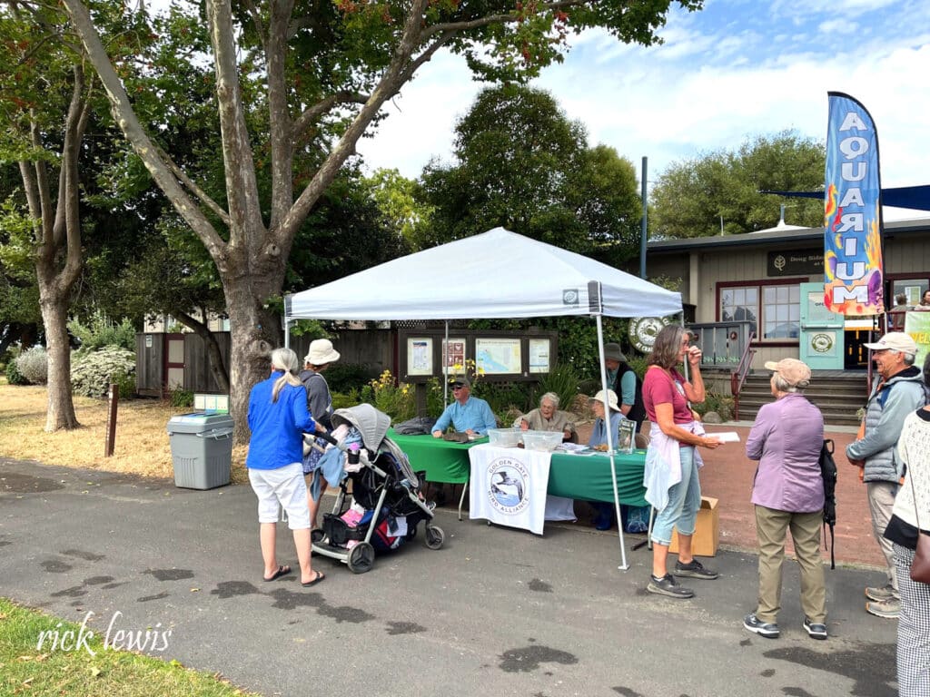 Alameda Post - in front of the Crab Cove visitor's center, a booth is set up, and people answer the public's questions