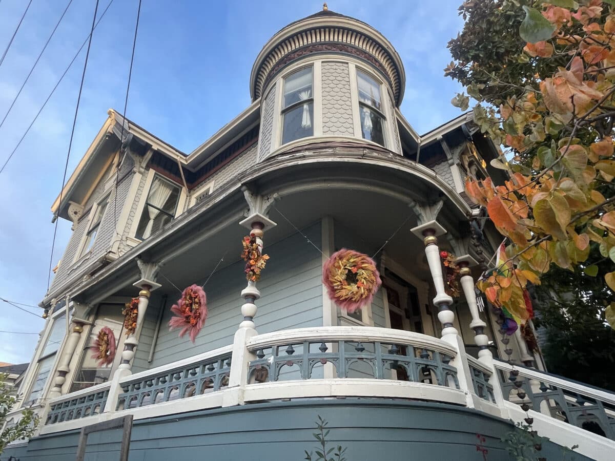 Alameda Post - the curving porch of a grand old Alameda house, with fall decorations hung