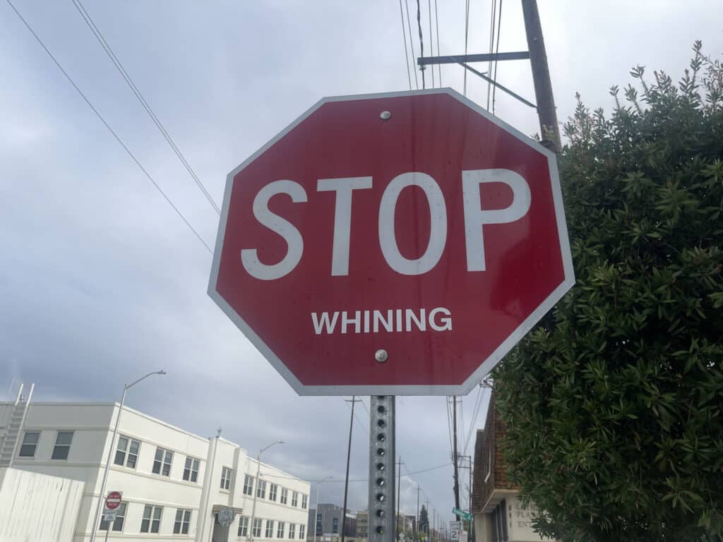 Alameda Post - a stop sign that says STOP with a stickers underneath that says "whining"