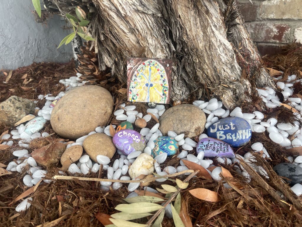 Alameda Post - rocks in a fairy garden with messages on them