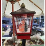 Alameda Post - an artistic street lamp outside that appears to be a snow globe with a small winter scene inside it