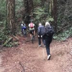 Alameda Post - two hikers are passed by two bikers on a narrow trail