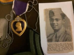 Alameda Post - a Purple Heart award and a newspaper clipping with a photo of a young man in the military