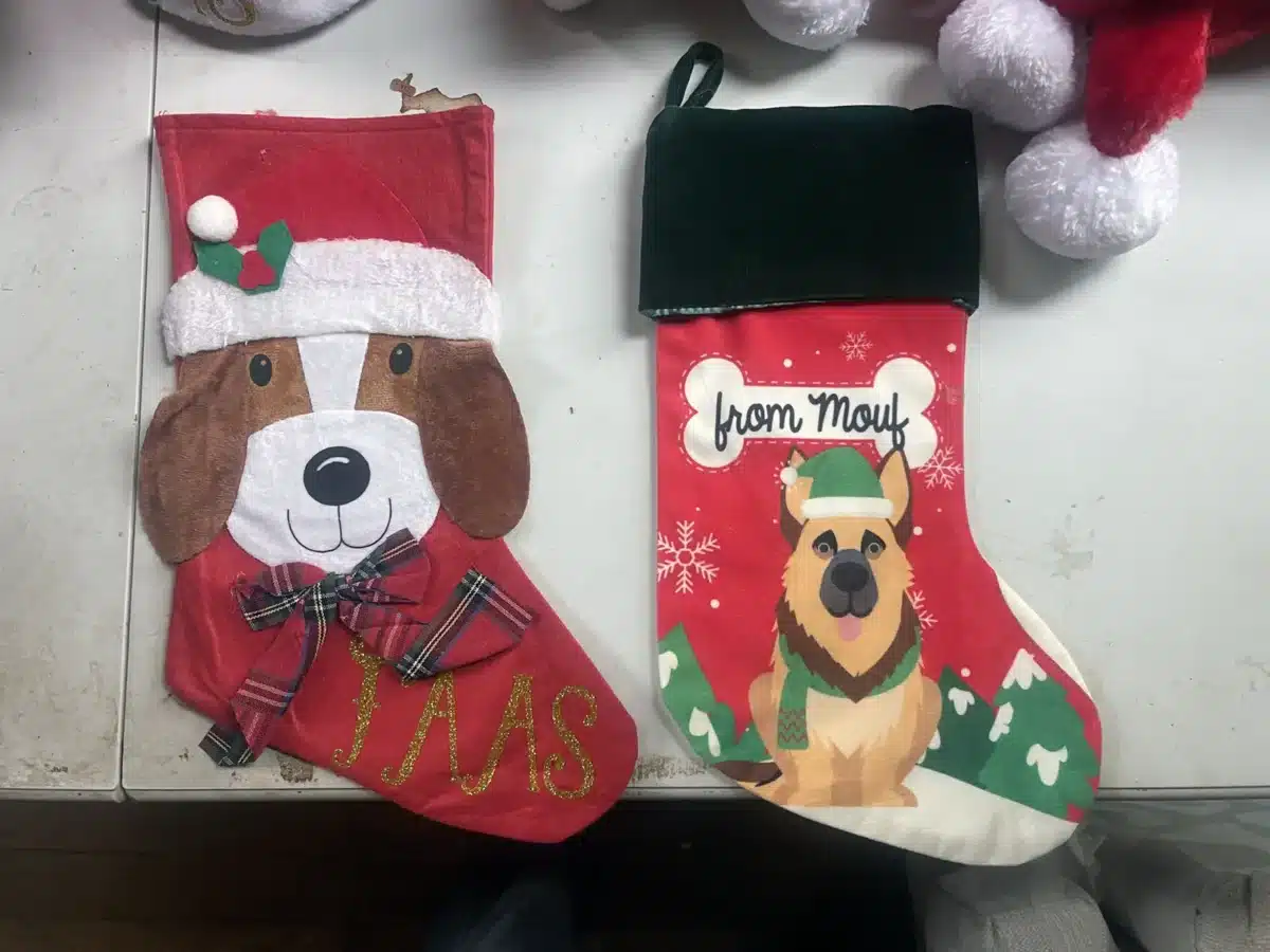 Alameda Post - Two Christmas stockings decorated with dogs, one says "FAAS" the other says "From Mouf"