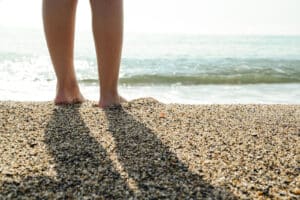Alameda Post - a person stands at the shoreline on the beach