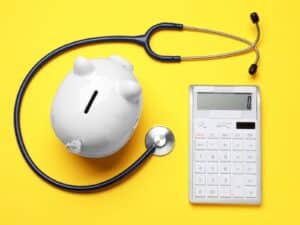 Alameda Post - a calculator, piggy bank, and stethoscope
