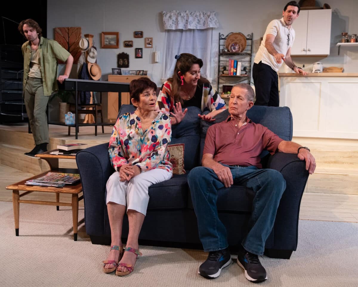 Alameda Post - onstage, a set looks like a home with a kitchen, dining area, and living area. Five actors interact.