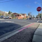 Alameda Post - in front of a stop sign, an intersection has been "daylighted" because red paid has been added to the curb for 20 feet