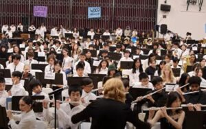 Alameda Post - a photo of the All City Band Concert, with a huge band being conducted by a director