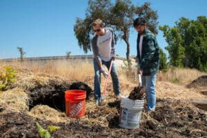 Alameda Post - two people shovel at REAP