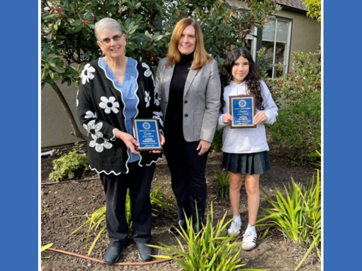 Alameda Post - an adult stands between the teacher and student of the month at St. Joseph Elementary School