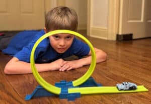 Alameda Post - a young boy plays with hot wheels