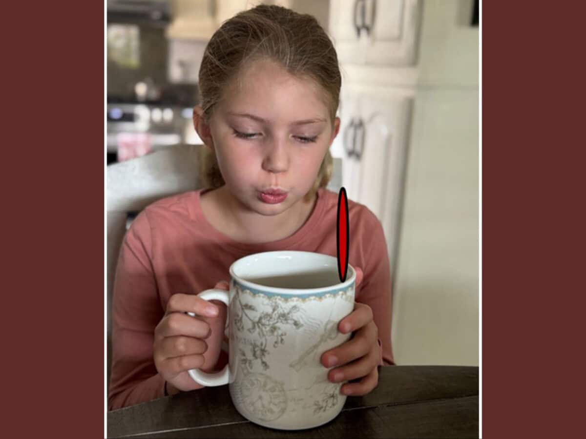Alameda Post - a young girl sits with a cut of tea