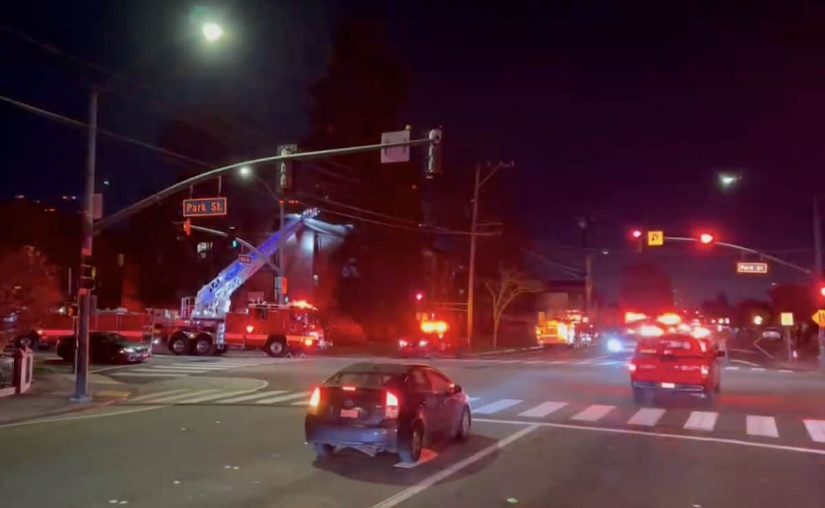 Alameda Post - at an intersection on Park Street near south shore center, a number of AFD vehicles with flashing lights are parked after responding to a fire