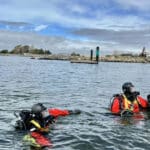 Alameda Post - two AFD members in the water in scuba gear
