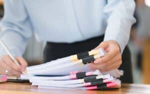 Alameda Post - a photo of somebody at a business sorting through a stack of papers