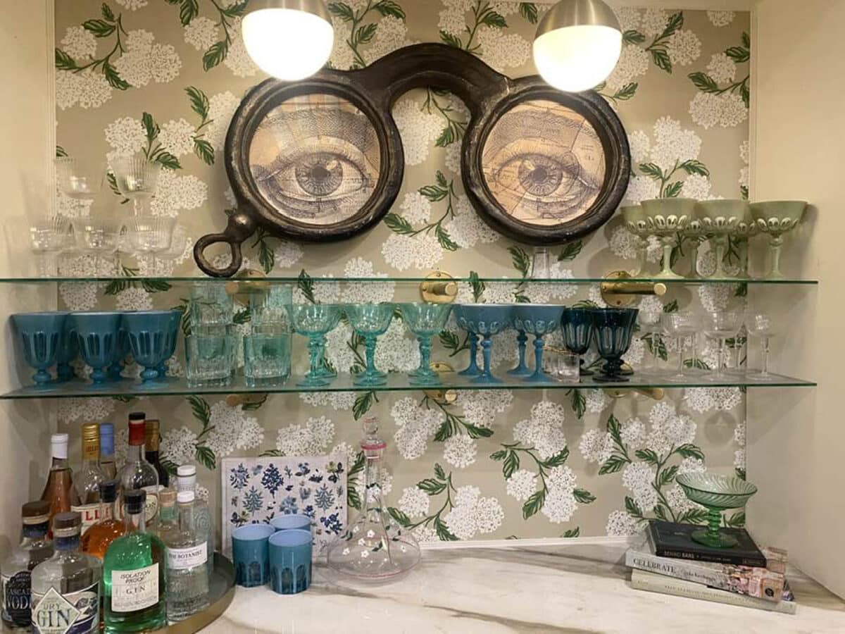 Alameda Post - decor including liquor bottles, glasses, and large eyes looking through glasses
