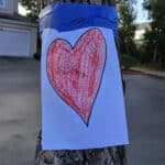 Alameda Post - a piece of printer paper with a heart drawn on it taped to a tree