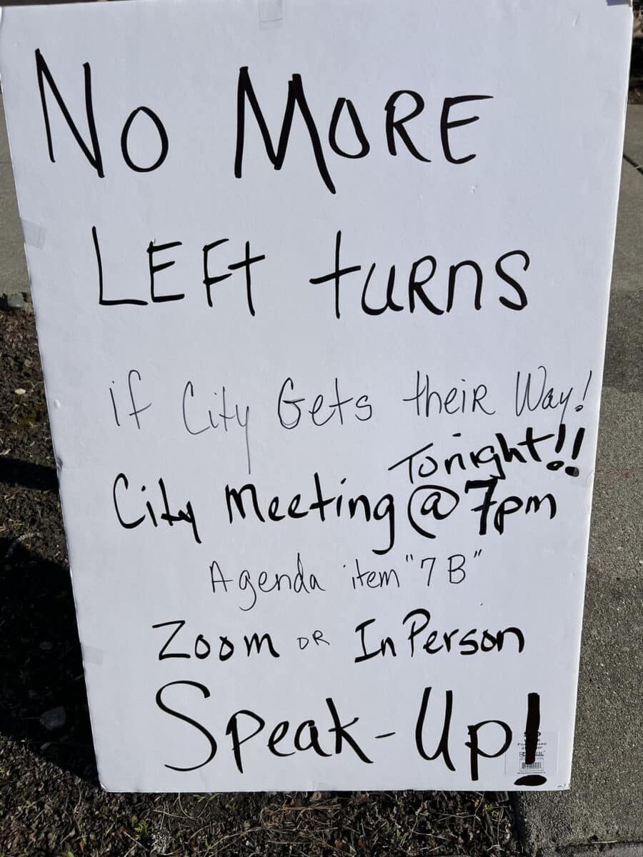 Alameda Post - a handwritten large sign that says, "No more left turns if City gets their way! City meeting tonight at 7p. Agenda item 7B. Zoom or In person. Speak up!"