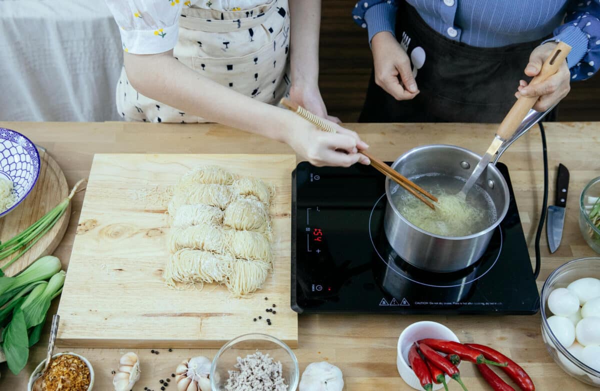 Alameda Post - two people cook on an induction cooktop 