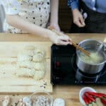 Alameda Post - two people cook on an induction cooktop