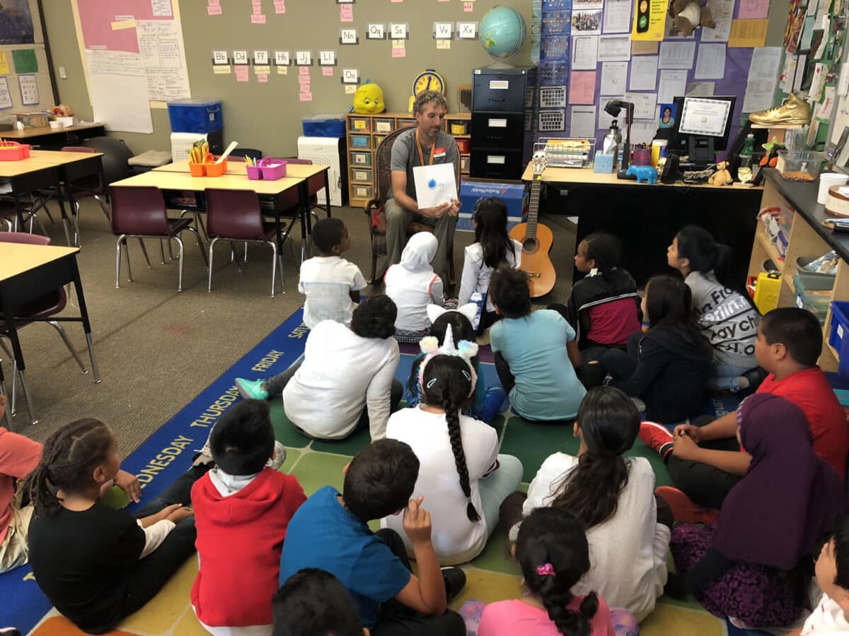 Alameda Post - a teacher, Andrew LaBarre, reads to a classroom of children