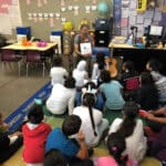 Alameda Post - a teacher, Andrew LaBarre, reads to a classroom of children