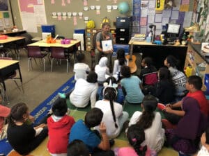 Alameda Post - a teacher, Andrew LaBarre, reads to a classroom of children