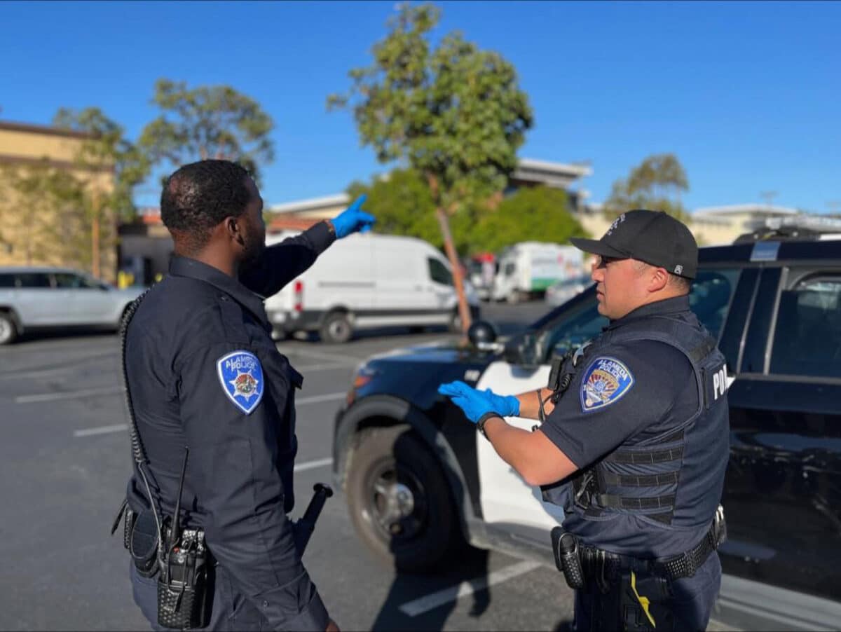Alameda Post - two APD officers converse in a parking lot