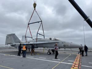 Alameda Post - people walk around a plane on the USS Hornet