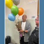 Alameda Post - teacher of the year Michael Wong holds a bunch of balloons