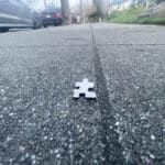 Alameda Post - a puzzle piece on the sidewalk
