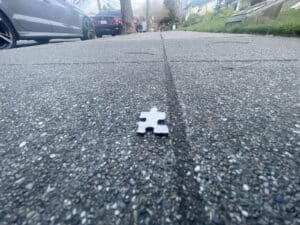 Alameda Post - a puzzle piece on the sidewalk