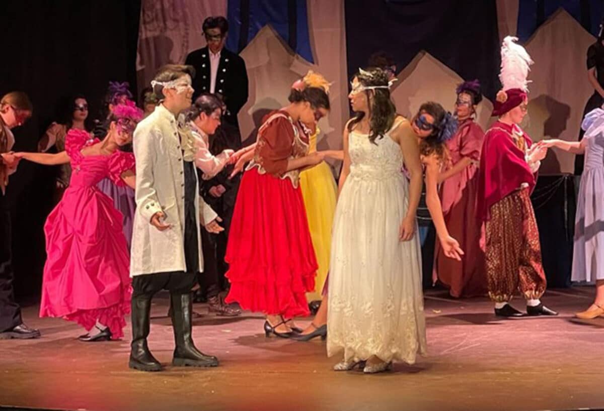 Alameda Post - a large cast in colorful costumes portray the masked ball in Cinderella
