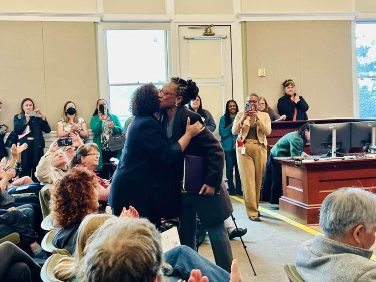 Alameda Post - Mia Bonta and Lateefah Simon embrace at the front of Council Chambers