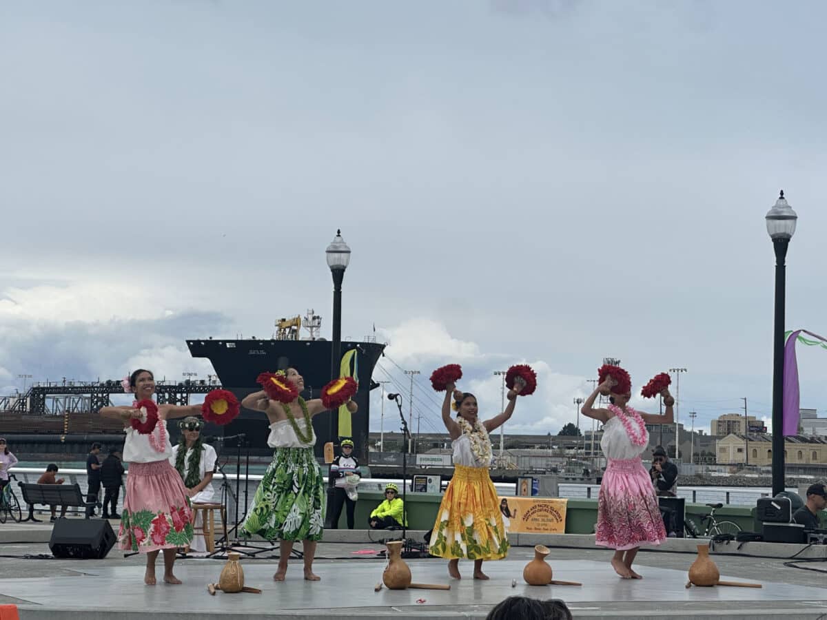 Alameda Post - four performers in bright clothing perform at the Asian & Pacific Islander Arts & Culture Festival