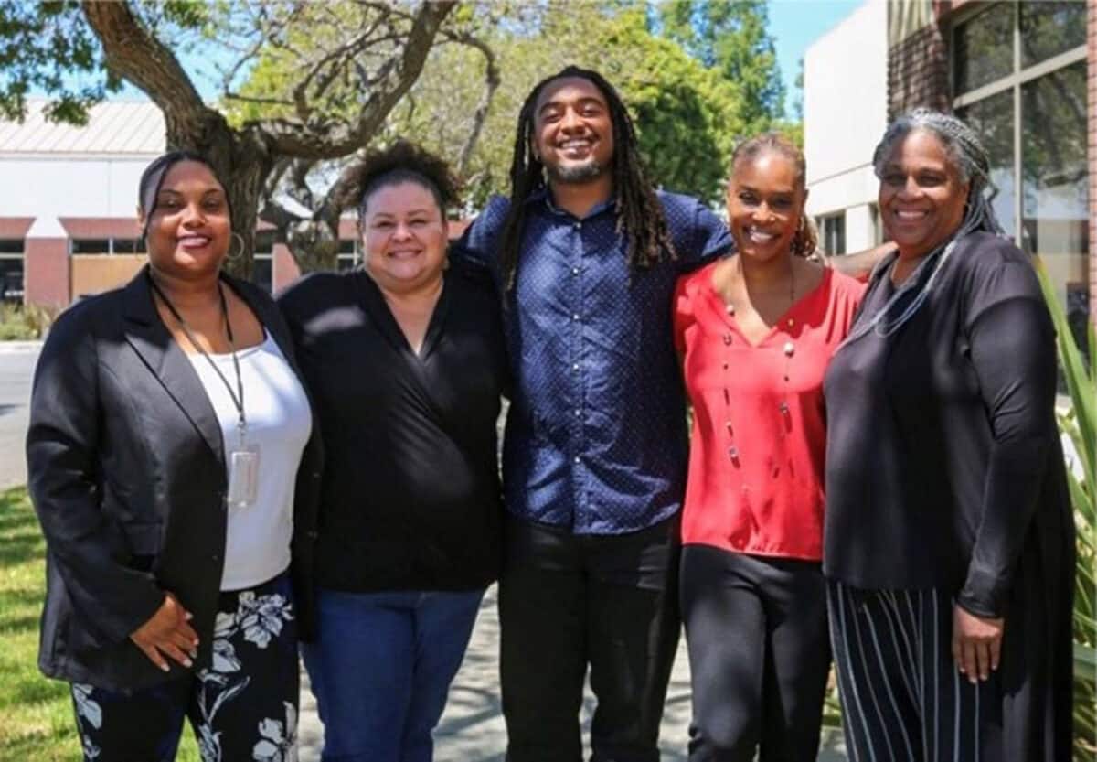 Alameda Post - five people of color who comprise the AUSD Office of Equity stand together and smile at the camera